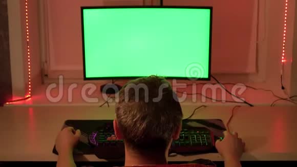 一个男人在他的家庭办公室在一个绿色的电脑屏幕前在家工作视频的预览图