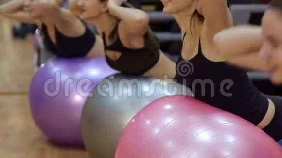 四个女孩在健身房里用健身球做运动视频的预览图