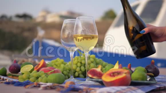 在海边品尝葡萄酒和新鲜水果视频的预览图