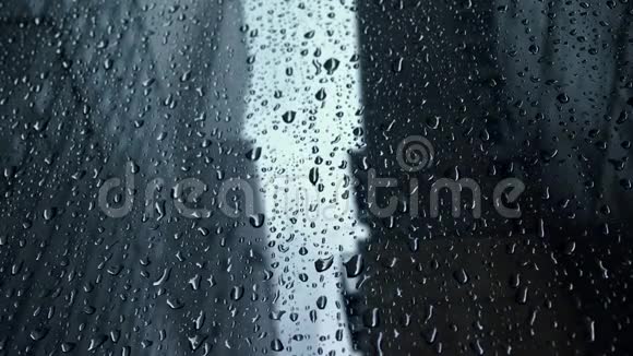 城市暴雨中窗户上的雨滴视频的预览图