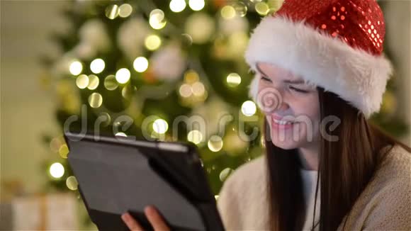 圣诞老人中情绪激动的女人在庆祝圣诞节时使用小玩意令人惊叹的长发和迷人的布鲁内特视频的预览图