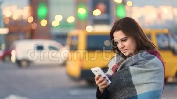 迷人的聪明的漂亮的年轻的可爱的女孩敲着电话在城市街道上微笑背景不集中视频的预览图