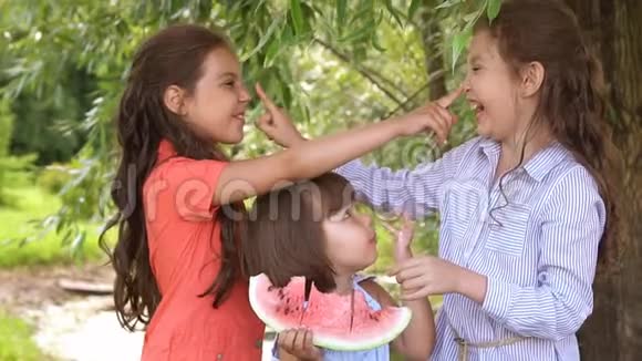 一群在户外吃西瓜的孩子慢动作视频的预览图