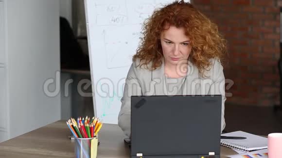 红头发的女商人匆匆忙忙地在工作场所视频的预览图