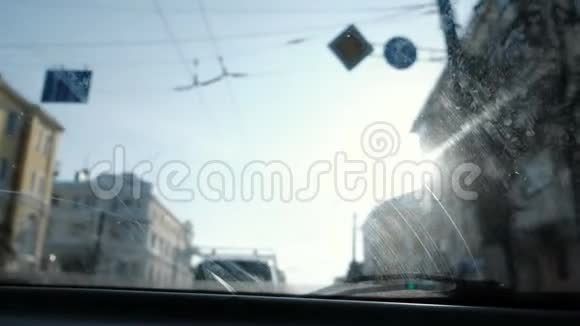 从汽车到城市的视野把注意力集中在脏的挡风玻璃上挡风玻璃雨刷可以操作视频的预览图