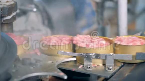 装满肉的锡罐正沿着传送带移动视频的预览图
