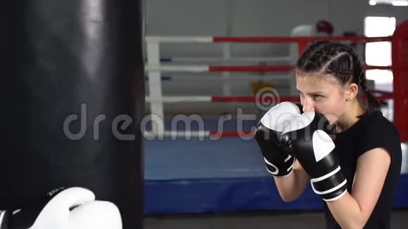 年轻的运动女孩会用拳击手套快速打拳慢动作视频的预览图
