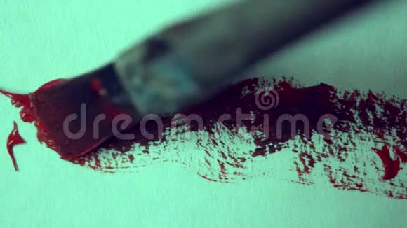 用画笔在白纸上画红色油漆特写视频的预览图