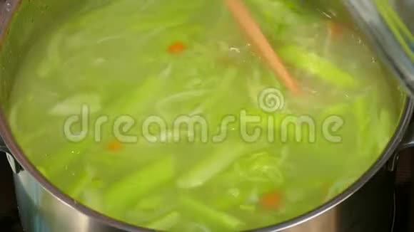 在平底锅中加入草药搅拌汤视频的预览图