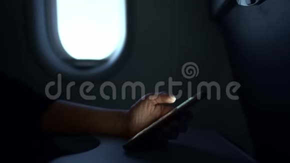 在飞机上拿智能手机的女人的手视频的预览图