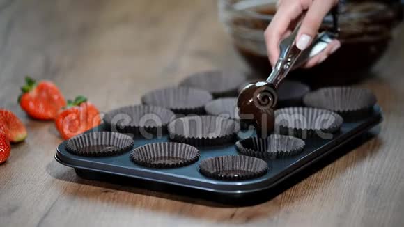 做巧克力松饼的女人将蛋糕拌入锅中视频的预览图