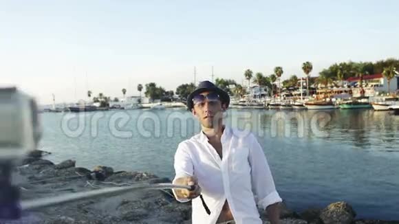 男子自拍照片站在美丽的海湾海岸视频的预览图