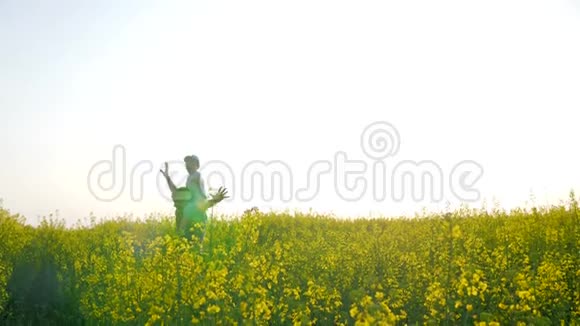 孩子坐在草地上的父亲肩膀上快乐的父亲和背光的男孩在后台玩飞机视频的预览图