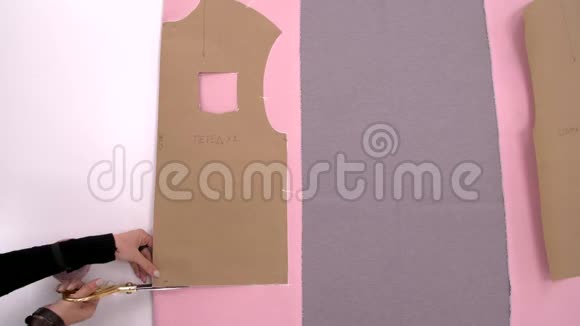 裁缝裁剪布料工作中的裁缝从粉红色的布料上缝一件运动衫车间进行服装裁剪设计视频的预览图
