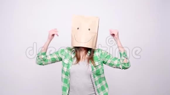 快乐的女人头上戴着纸袋跳舞视频的预览图