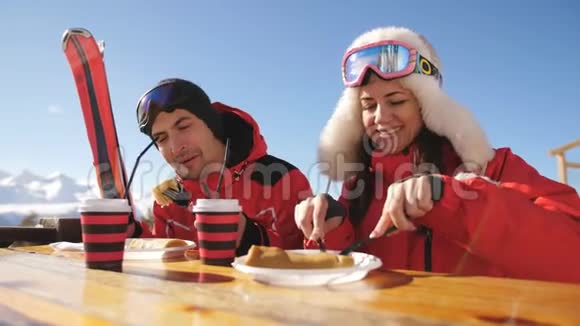 男人和女人在山顶上的餐厅吃午饭滑雪场视频的预览图