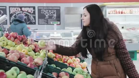 在杂货店买新鲜苹果的女人视频的预览图