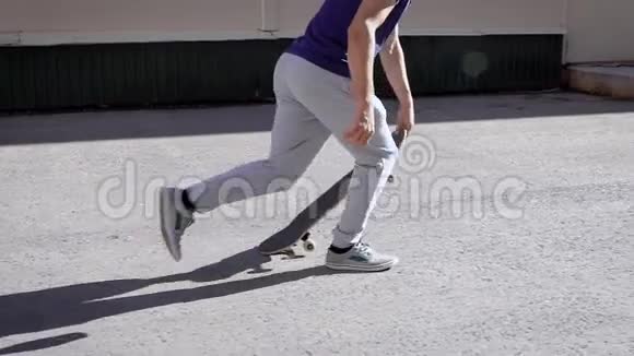 一个穿着街头服装在滑板上踢翻的男滑板手的特写镜头人们享受生活视频的预览图