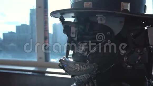 戴帽子的男子详细机器人头的特写录像全景背景下帽子机器人头部特写视频的预览图