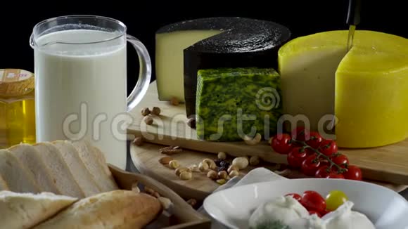 在黑色背景下一个罐子和一杯牛奶一个奶酪烤面包蜂蜜和鸡蛋的旧风格的静止生活视频的预览图