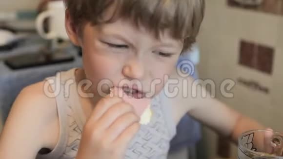 男孩吃三明治喝饮料这个男孩正在吃早餐视频的预览图