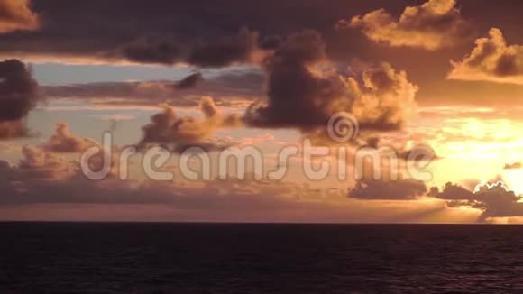 一个迷人的日落在海洋与不可思议的色彩的云和天视频的预览图