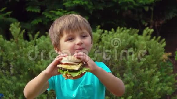 男孩吃大汉堡加奶酪视频的预览图