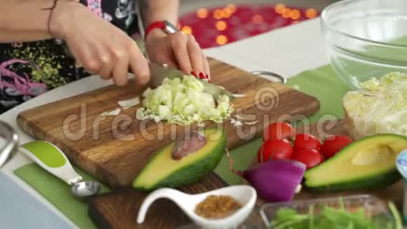 女人的手用刀切萝卜做沙拉把新鲜蔬菜放在厨房的桌子上家庭主妇做饭自然视频的预览图