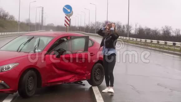一个女人在雨中的道路上发生了事故她受伤了害怕了视频的预览图