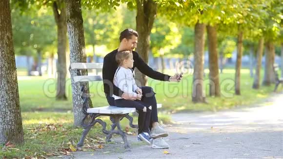 秋天的幸福家庭爸爸和小孩在美丽的秋日尽情自拍视频的预览图