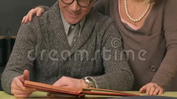 年长夫妇看着旧相册视频的预览图