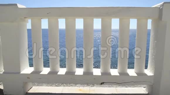 白色楼梯通向完美的蓝色海洋和海滩夏季景观与经典白色栏杆和空露台视频的预览图