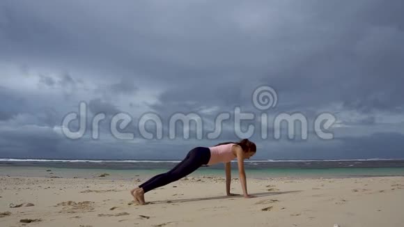 在海前海滩上训练女人一手一腿木板锻炼视频的预览图