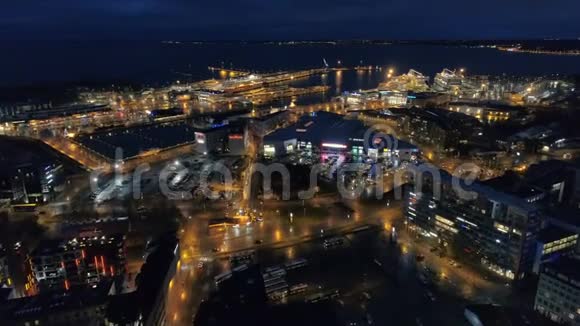 夜晚城市的空中景观街道照明靠近大海和港口的船只移动交通视频的预览图
