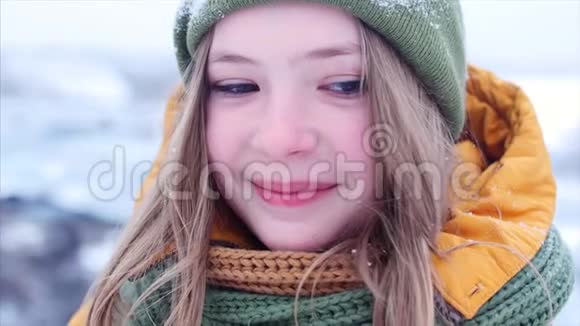 一位年轻美丽的少女的特写肖像金发随风飘动在户外享受冬日视频的预览图
