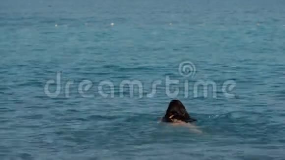 阳光明媚的一天长发少女在海里游泳视频的预览图
