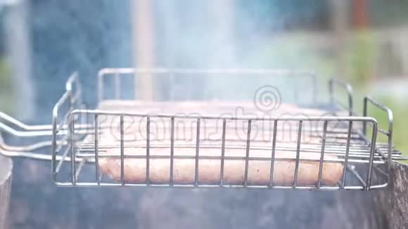 烤架上的香肠用木炭烤侧视视频的预览图