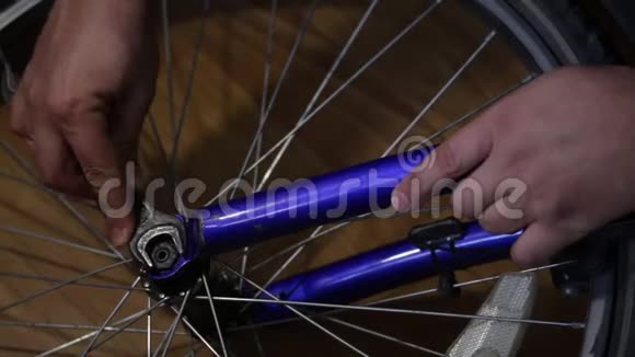 那个人把自行车上的轮子摘下来用扳手拧开螺母视频的预览图