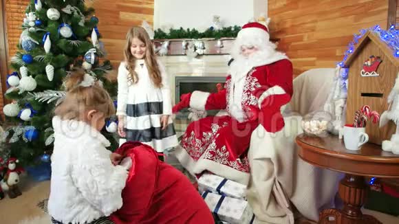 小女孩帮圣诞老人送圣诞礼物圣尼古拉斯冬季住宅儿童礼物视频的预览图
