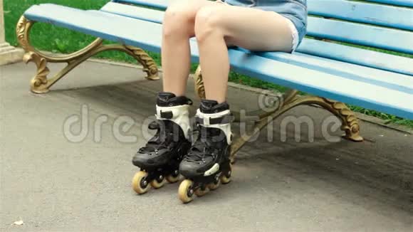 一个年轻女孩坐在公园里玩滑轮车视频的预览图