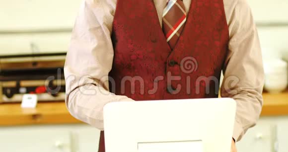 使用数码平板电脑的人站着视频的预览图