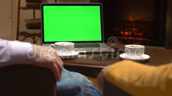 咖啡桌上的绿屏模拟笔记本电脑视频的预览图