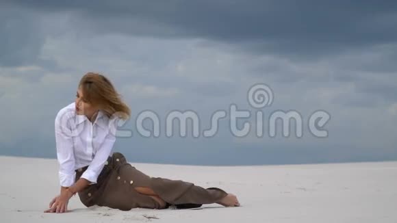 一个女孩把她的手放在沙子上视频的预览图