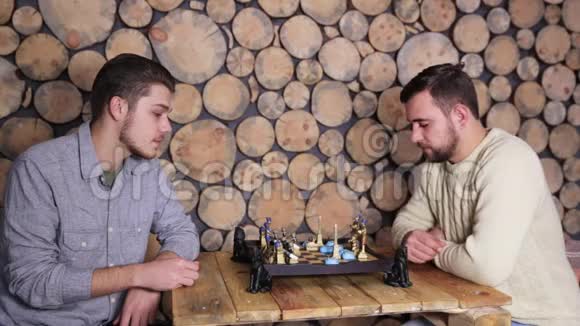 年轻的白种人男性朋友在家一起下棋伍德姆框架背景视频的预览图