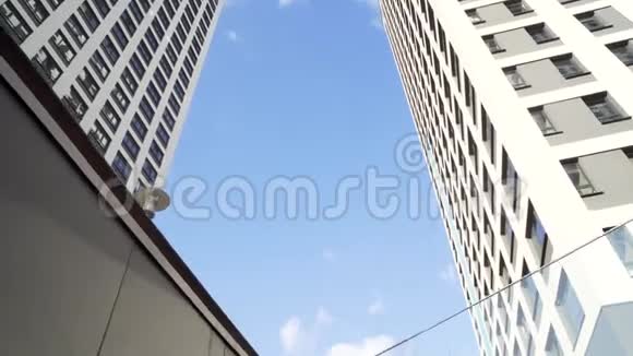 仰望蓝天背景上的一群现代写字楼框架阳光明媚的日子里玻璃城的建筑视频的预览图