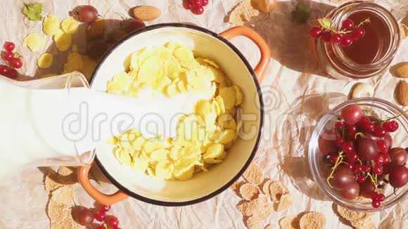 在羊皮纸上有一个碗碗里有雪花和浆果靠近蜂蜜视频的预览图