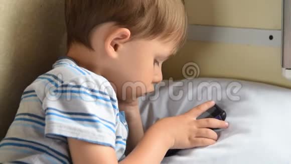 在火车上玩手机游戏的男孩视频的预览图