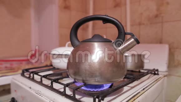 天然气火焰上的水壶特写镜头晚上喝茶有开水的茶壶视频的预览图