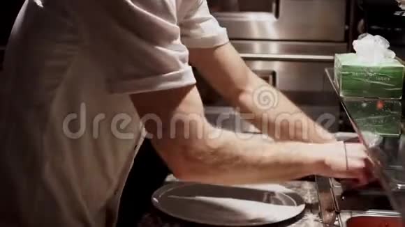 厨师的多重任务厨师用生披萨和切准备好的食物视频的预览图