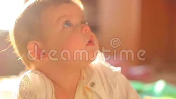 六个月大的婴儿躺在床上迷人地微笑家里的小蓝眼睛小孩视频的预览图